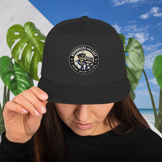 Boundless And Lost explorer dad hat with Bones and Rico logo